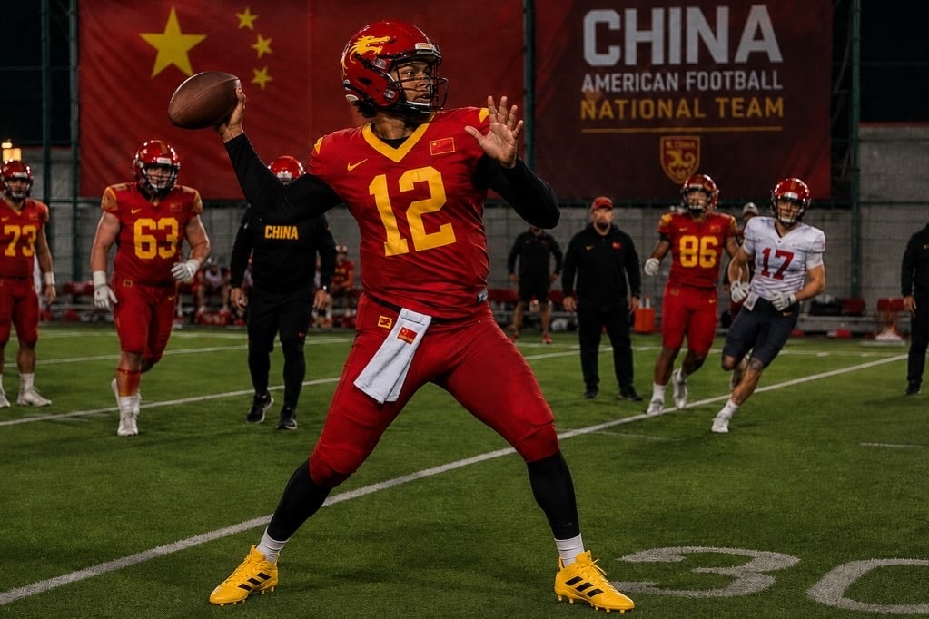 China American football quarterback in red number 12 uniform preparing to throw